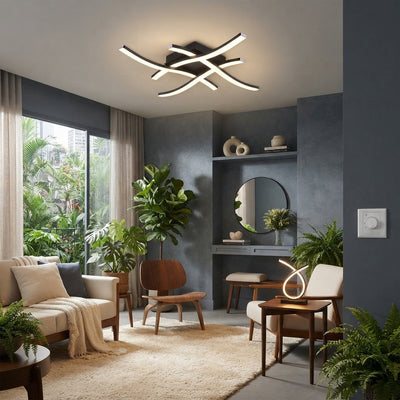A modern curved LED lamp placed on a wooden side table inside a contemporary living room with neutral decor.